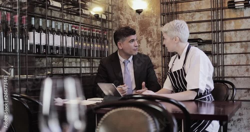 Chef and restaurant owner talking with financial advisor investor