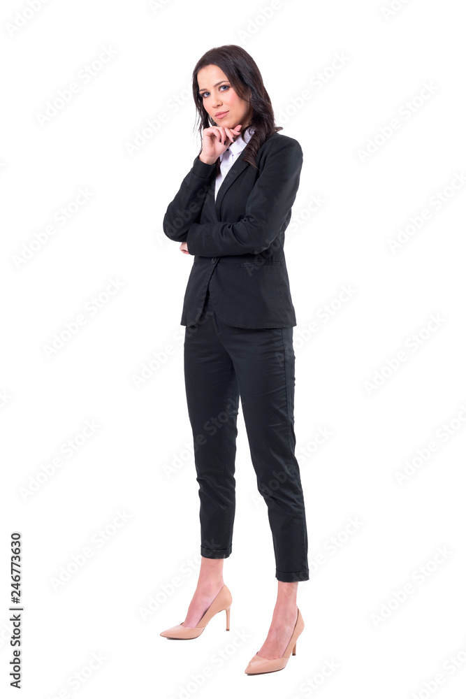 Confident successful business woman in black formal suit standing and looking at camera. Full body isolated on white background. Confident successful business woman in black formal suit standing and looking at camera. Full body isolated on white background.