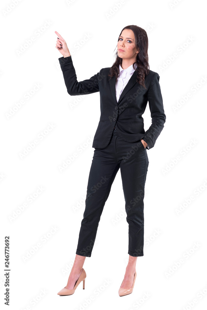 Serious confident businesswoman pointing finger up doing presentation. Full body isolated on white background. Serious confident businesswoman pointing finger up doing presentation. Full body isolated on white background.