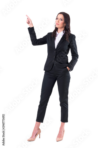 Serious confident businesswoman pointing finger up doing presentation. Full body isolated on white background. 