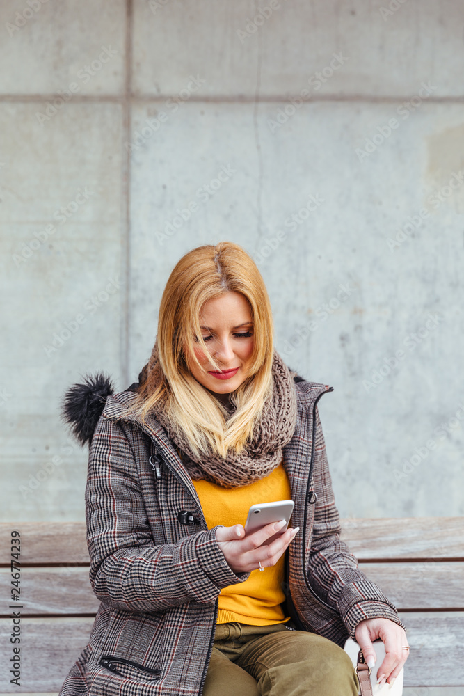 Portrait of blonde woman using her mobile phone Portrait of blonde woman using her mobile phone