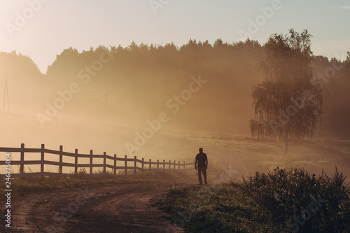 silhouette of man standing at sunrise