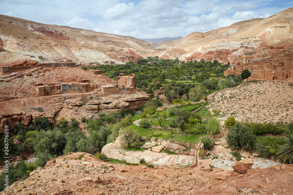 Green oasis in an arid desert landscape with old Berber villages in the surrounding valley of the Atlas Mountains in Morocco, near Ouarzazate