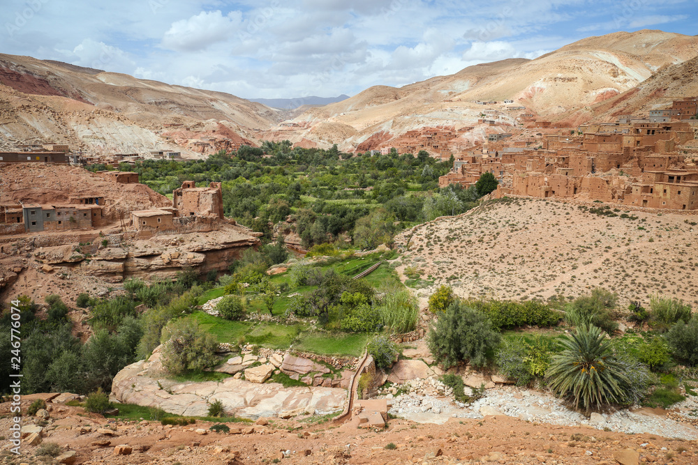 Green oasis in an arid desert landscape with old Berber villages in the surrounding valley of the Atlas Mountains in Morocco, near Ouarzazate