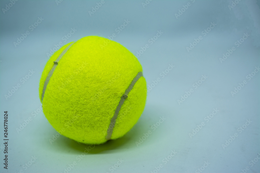 Yellow tennis ball that is sport equipment for tennis as international sport around the world.