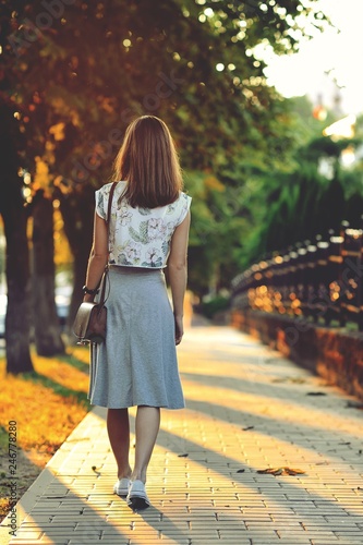 Woman walking away photo