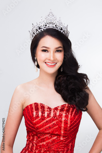 Portrait of Miss Pageant Contest in Asian Red Sequin Evening Ball Gown dress with Silver Diamond Crown Sash, fashion make up face hair style, studio lighting white background isolated copy space