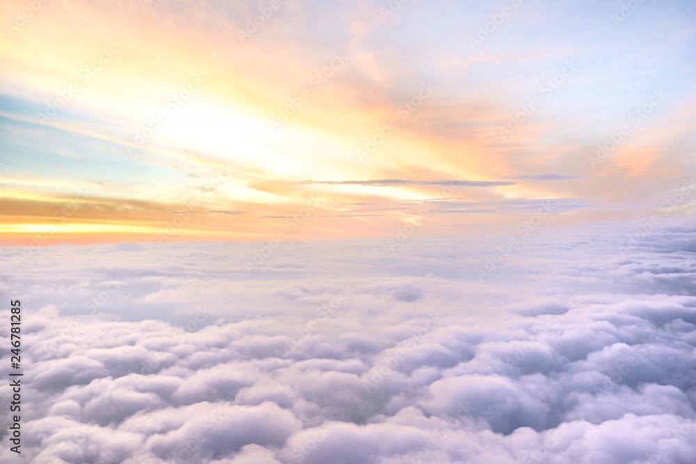 Sunny sky abstract background,Beautiful cloudscape on the atmosphere heaven.Scenic view sunrise over white fluffy clouds from the airplane window.Freedom,Nature,Backdrop Concept.Copy space for text.