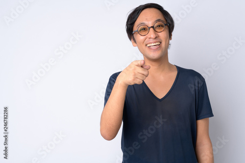 Portrait of happy Japanese man pointing at camera