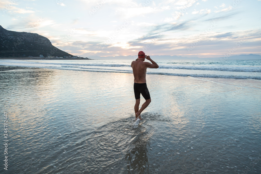 Senior man preparing to swim in the sea at dawn