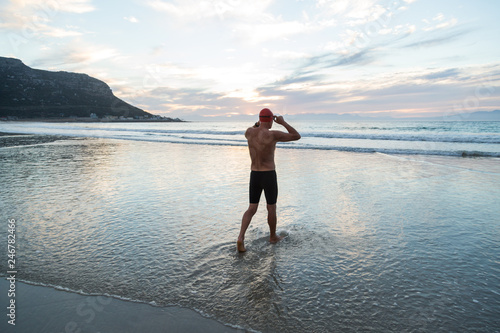 Senior man preparing to swim in the sea at dawn