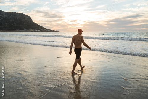 Senior man preparing to swim in the sea at dawn