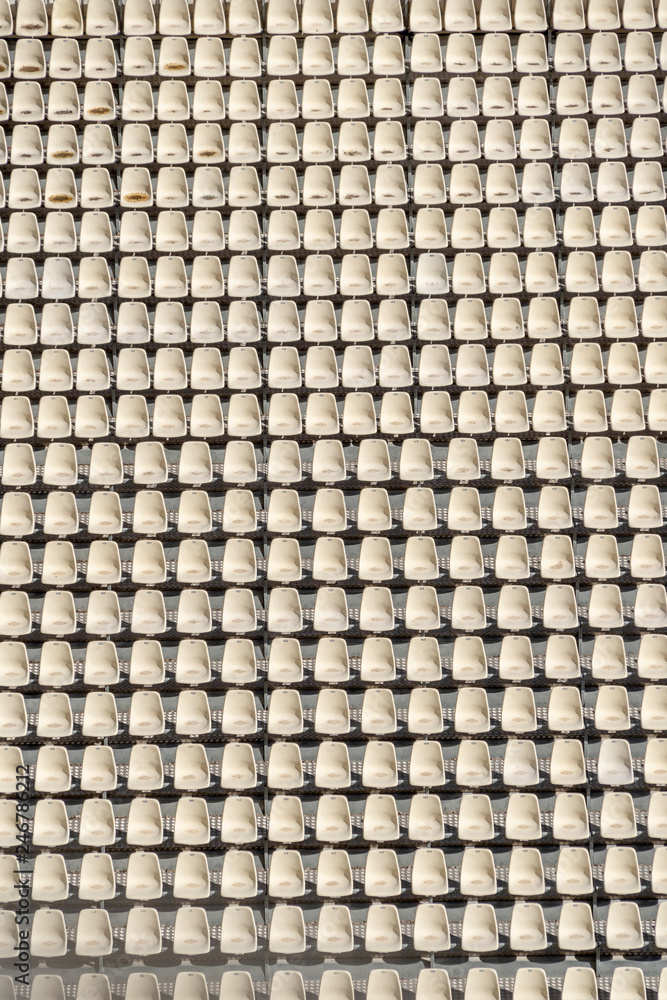 empty white seats with a boy sitting waiting empty white seats with a boy sitting waiting