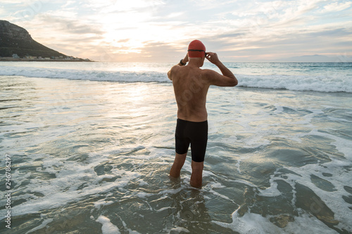 Senior man preparing to swim in the sea at dawn