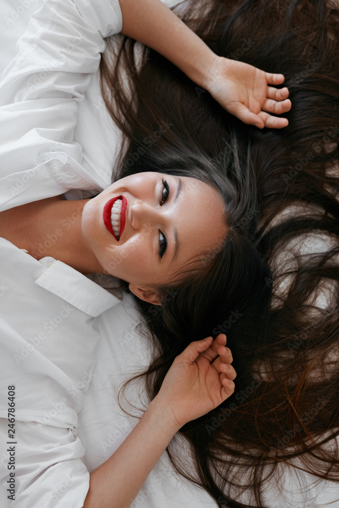 Beautiful woman with long hair, red lips makeup in white shirt Beautiful woman with long hair, red lips makeup in white shirt