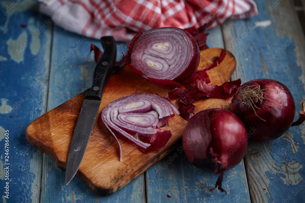 Red Onion Slices on wooden board with dark background Red Onion Slices on wooden board with dark background