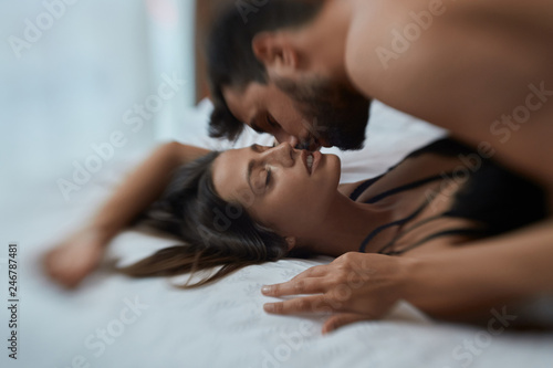 Sexy lovers in passion - couple in bed having sex.. photo