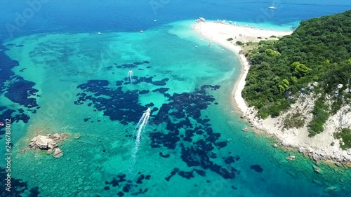 Aerial drone video of tropical island with volcanic caves and exotic emerald sea colour sandy beach