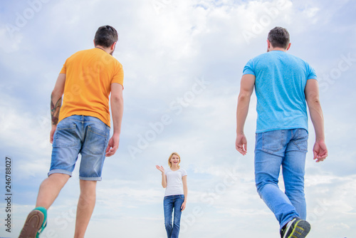 Summery fresh and brigh. Pretty woman and men friends walking outdoor. Fashion people look casual in summer outfit. Group of people in casual wear. Young people in casual style on cloudy sky