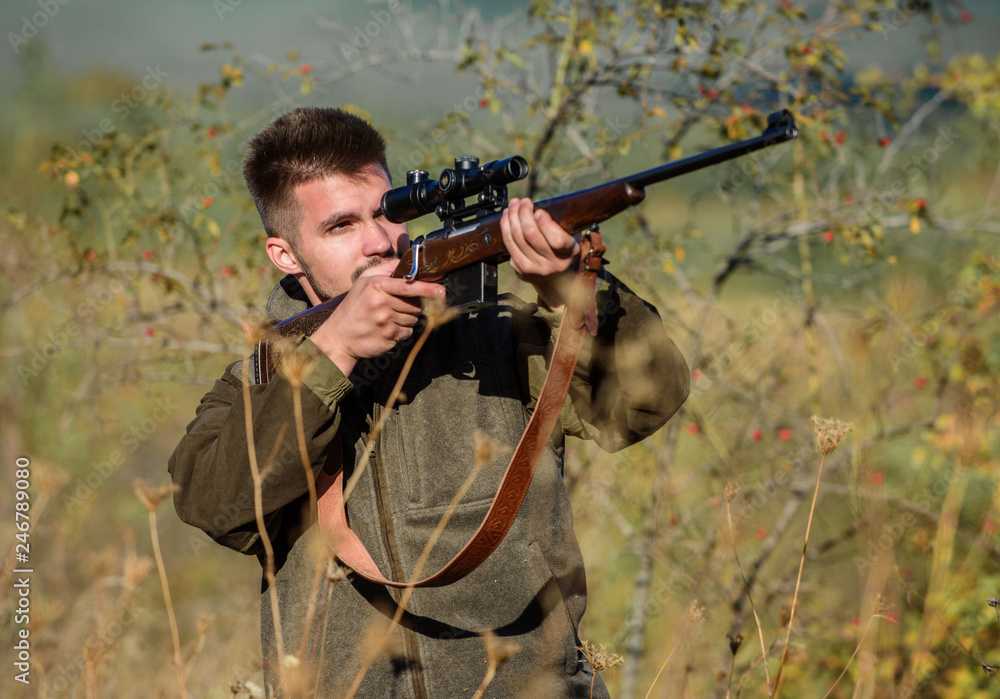 Hunting permit. Bearded hunter spend leisure hunting. Hunting equipment for professionals. Hunting is brutal masculine hobby. Man aiming target nature background. Hunter hold rifle. Aiming skills Hunting permit. Bearded hunter spend leisure hunting. Hunting equipment for professionals. Hunting is brutal masculine hobby. Man aiming target nature background. Hunter hold rifle. Aiming skills