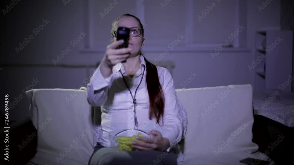 lifestyle woman watching TV at night on the sofa and eating chips
lifestyle woman watching TV at night on the sofa and eating chips