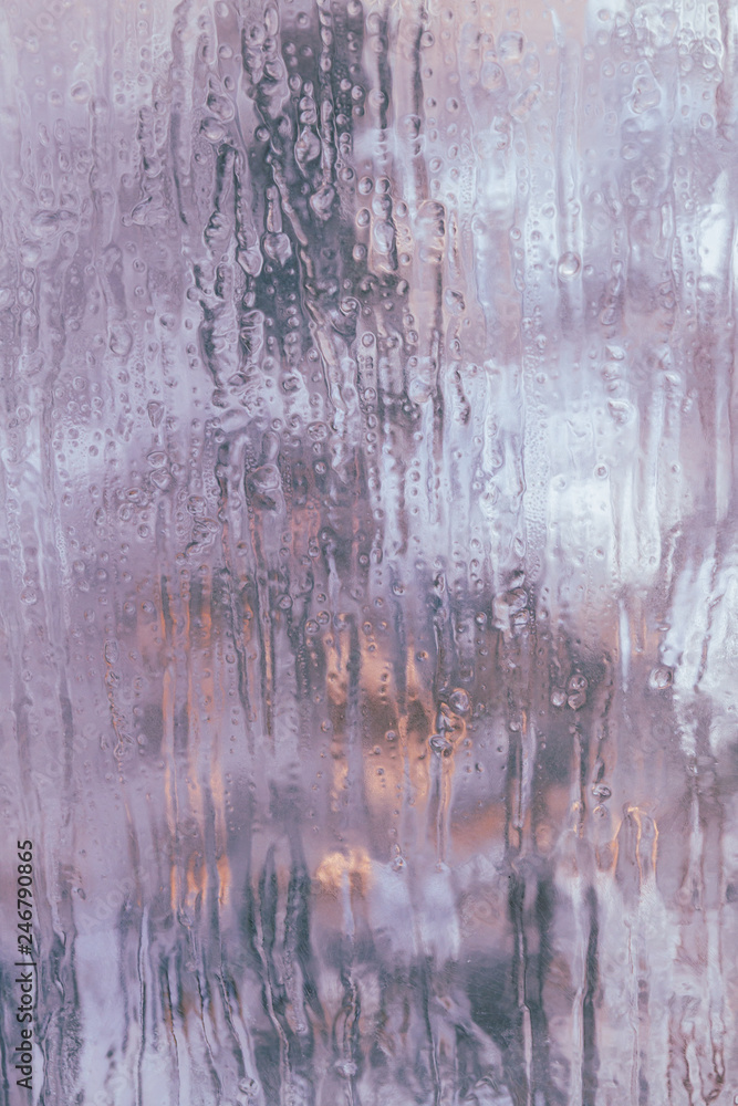 Frozen window in winter with drops and drips