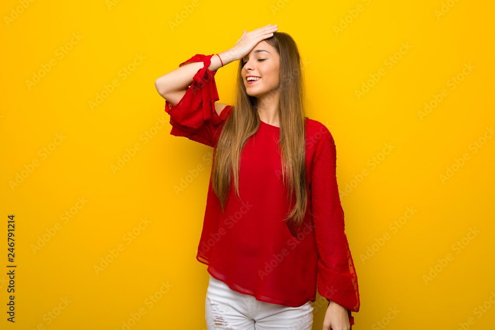 Young girl with red dress over yellow wall has just realized something and has intending the solution Young girl with red dress over yellow wall has just realized something and has intending the solution