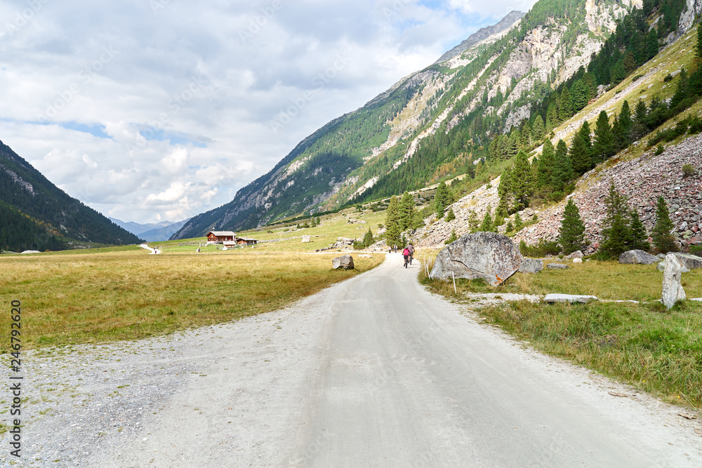 Hiking and biking on a trail in Krimml valley in Austria Hiking and biking on a trail in Krimml valley in Austria