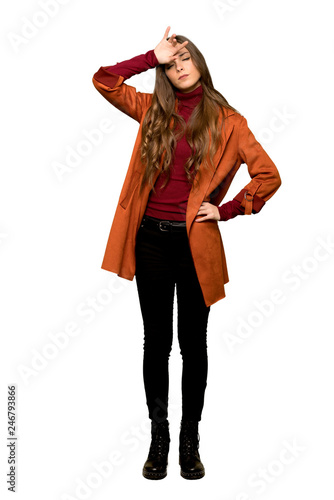 Full-length shot of Young woman with coat with tired and sick expression on isolated white background