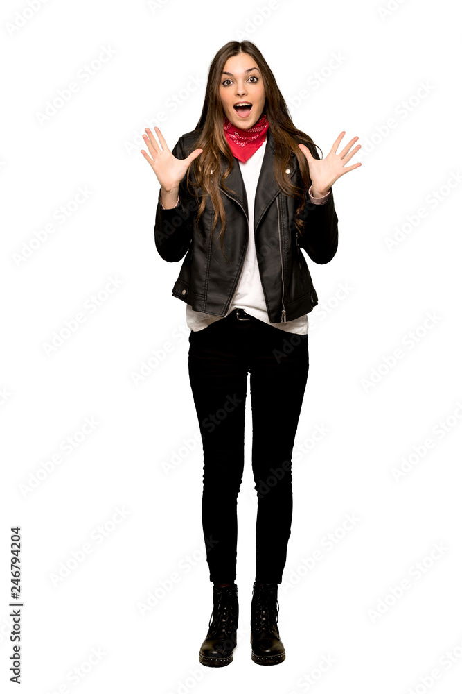 Full-length shot of Young woman with leather jacket with surprise and shocked facial expression on isolated white background Full-length shot of Young woman with leather jacket with surprise and shocked facial expression on isolated white background