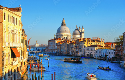 Beautiful view of Canal Grande with boats and tourists and Basilica Santa Maria della Salute in Venice Italy