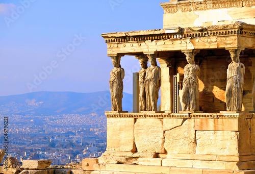 Athens Acropolis, Detail of Erectheion temple with caryatids and panoramic view of the Athens in background, Greece                     photo