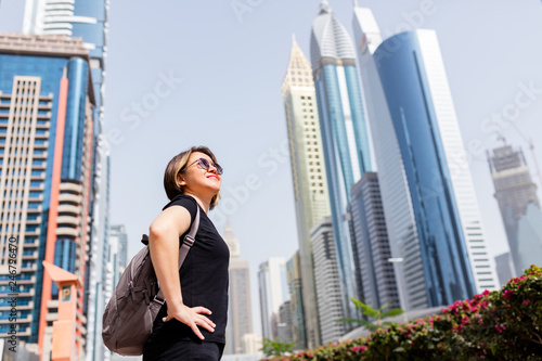 Adult woman between buildings.