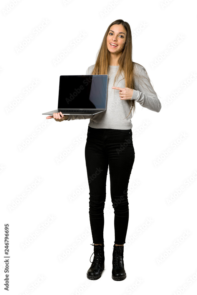 Full-length shot of young girl showing a laptop on isolated white background Full-length shot of young girl showing a laptop on isolated white background