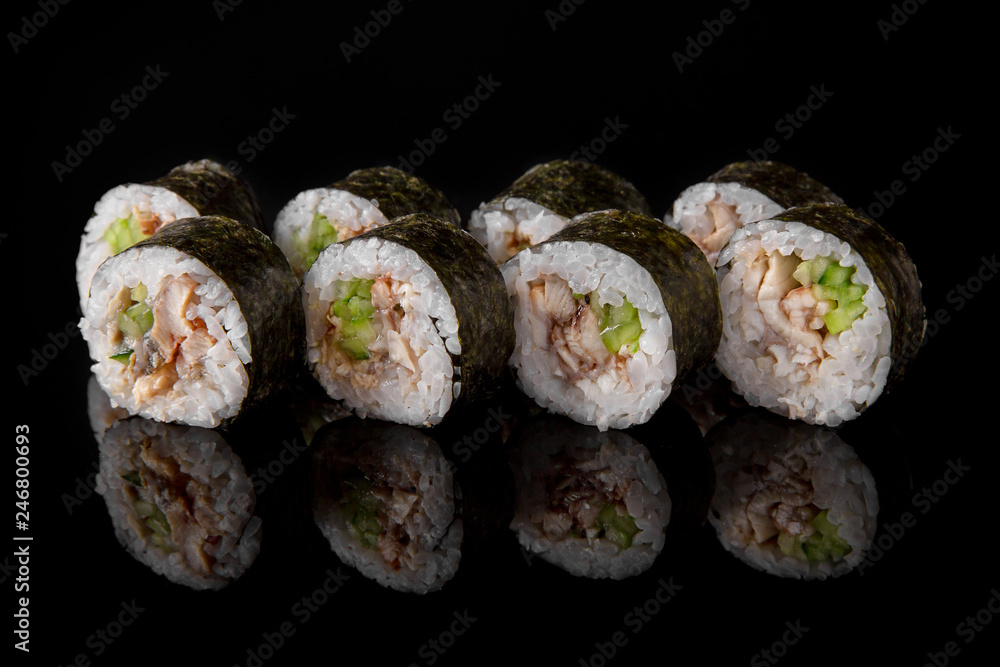 Maki Sushi Rolls with smoked eel, avocado and cheese on black background. Sushi menu. Japanese food. 