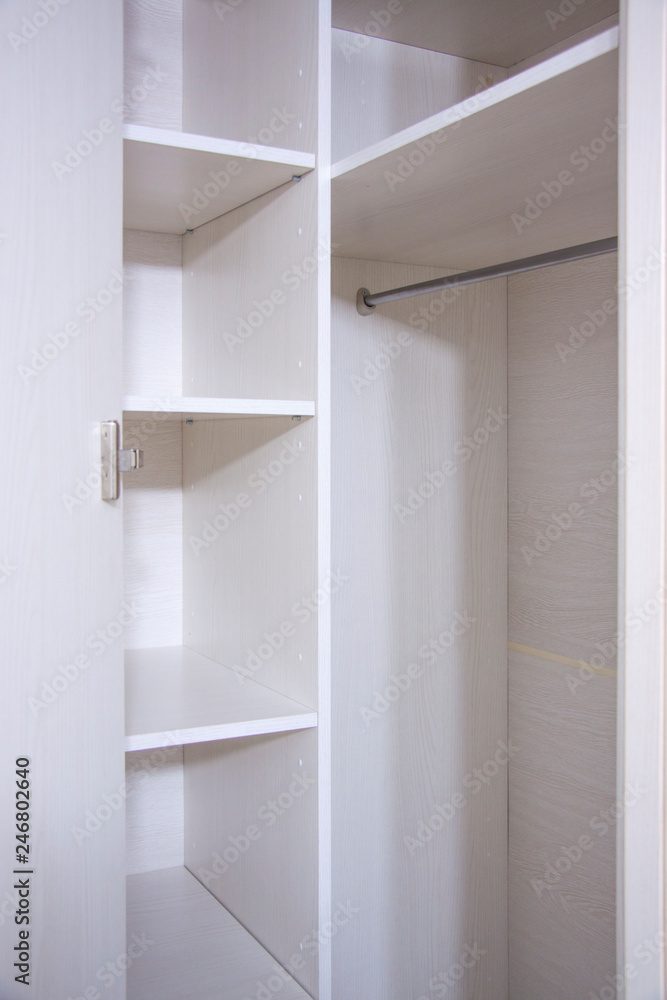 Installation of furniture indoors. Repair and assembly of light wooden wardrobe Installation of furniture indoors. Repair and assembly of light wooden wardrobe