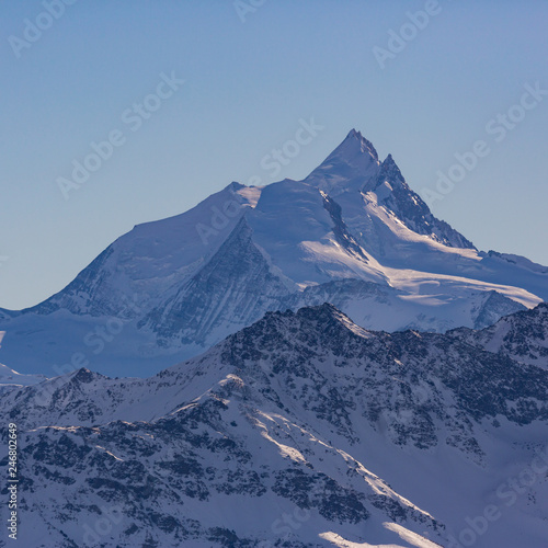 summit of Weisshorn mountain in Switzerland in winter, blue sky