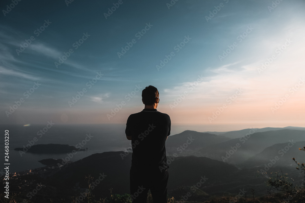 life style. guy on top of the mountains at sunset light, view of the mountains. Montenegro