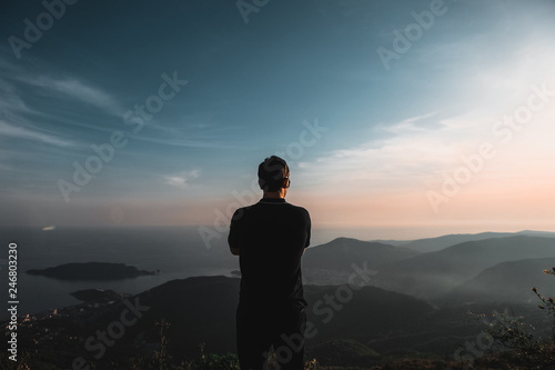 life style. guy on top of the mountains at sunset light  view of the mountains. Montenegro