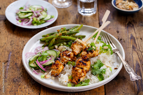 Satay chicken skewers with pickled cucumber salad