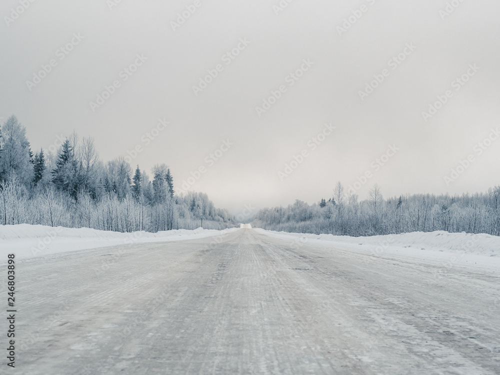 Winter road through the wild forest. Winter road through the wild forest.
