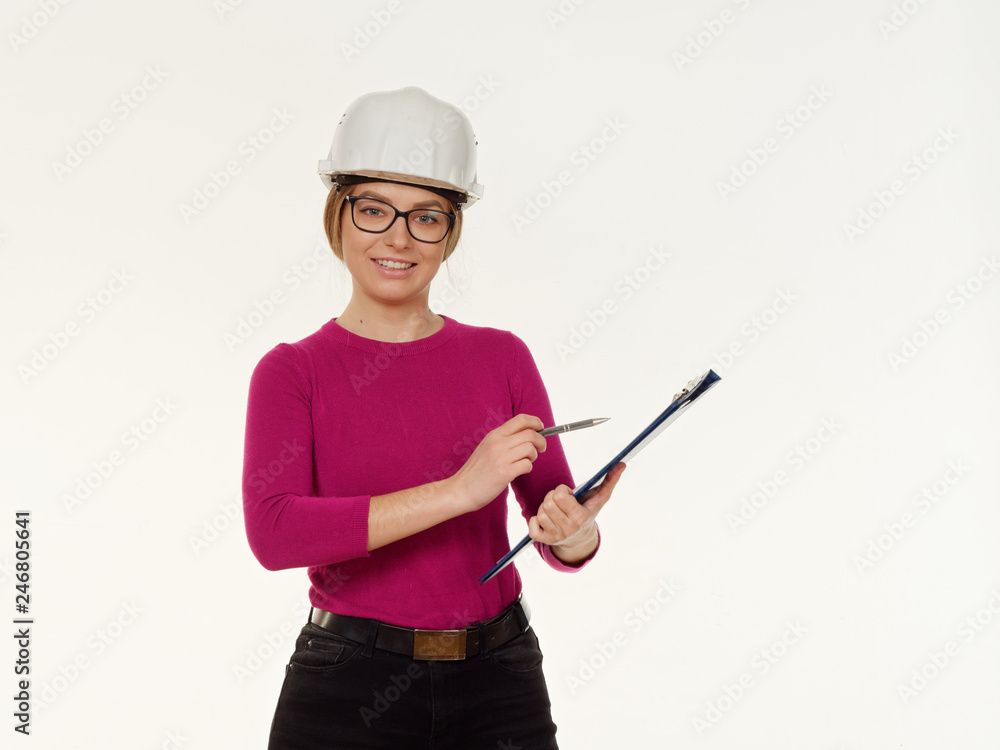 Fototapeta premium emotional girl foreman in a helmet on a white background.