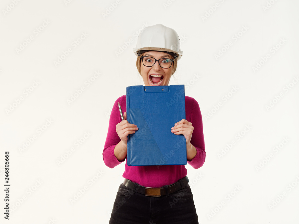 emotional girl foreman in a helmet on a white background. emotional girl foreman in a helmet on a white background.