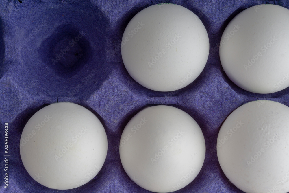 White eggs closeup in egg tray with selective focus and crop fragment White eggs closeup in egg tray with selective focus and crop fragment