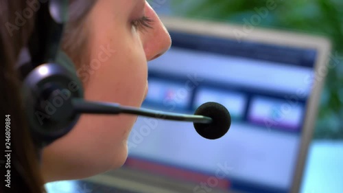 Female Call Center Employee Working
This stock footage features a dolly shot of a female call center employee working. She is sitting at her office desk with a laptop in front of her.