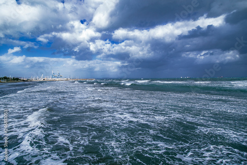 Beautiful stormy weather, cloudy blue sky and waves on Mediterranean Sea in Larnaca beach, Cyprus