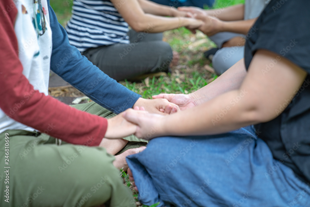 hand holds together in the community in the garden / park. hand holds together in the community in the garden / park.