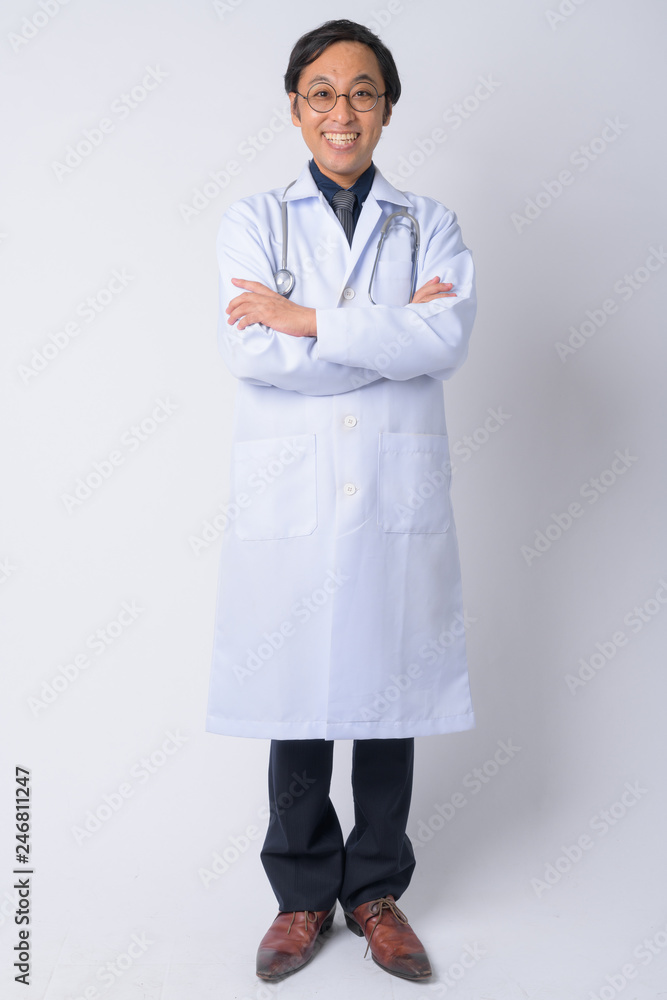Full body shot of happy Japanese man doctor with arms crossed Full body shot of happy Japanese man doctor with arms crossed