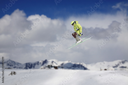 Flying skier on snowy mountains. Extreme winter sport, alpine ski. Copy space.