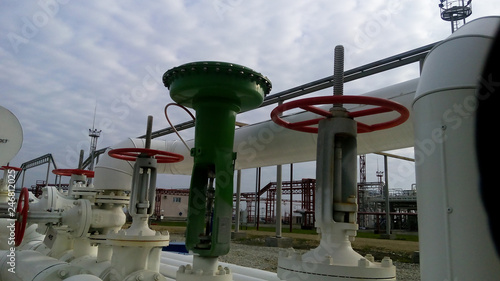 Green pneumatic valve on the pipeline photo